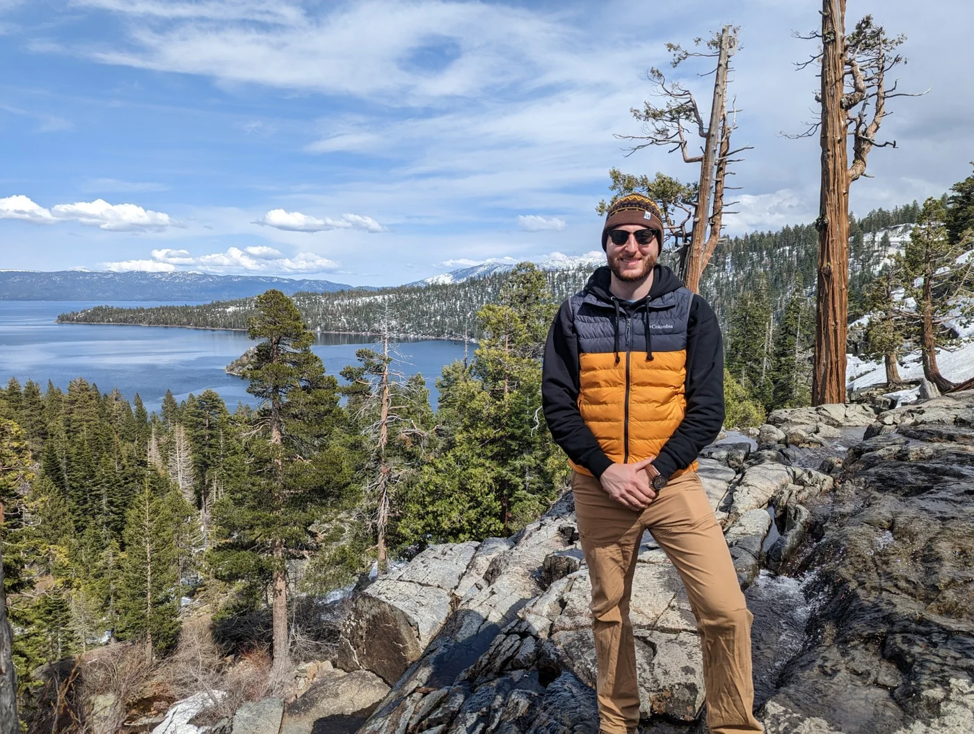 The founder of Three Rivers Genealogical Services standing beside a mountain lake